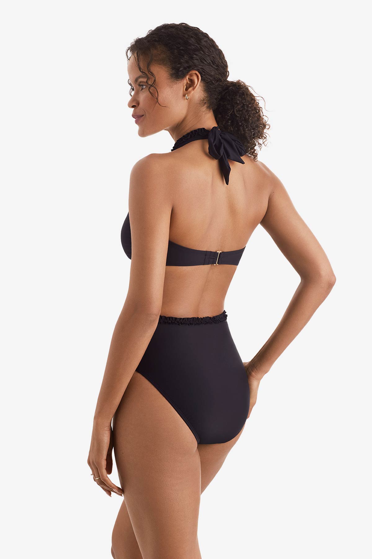Woman faced left wearing a black one-piece swimsuit