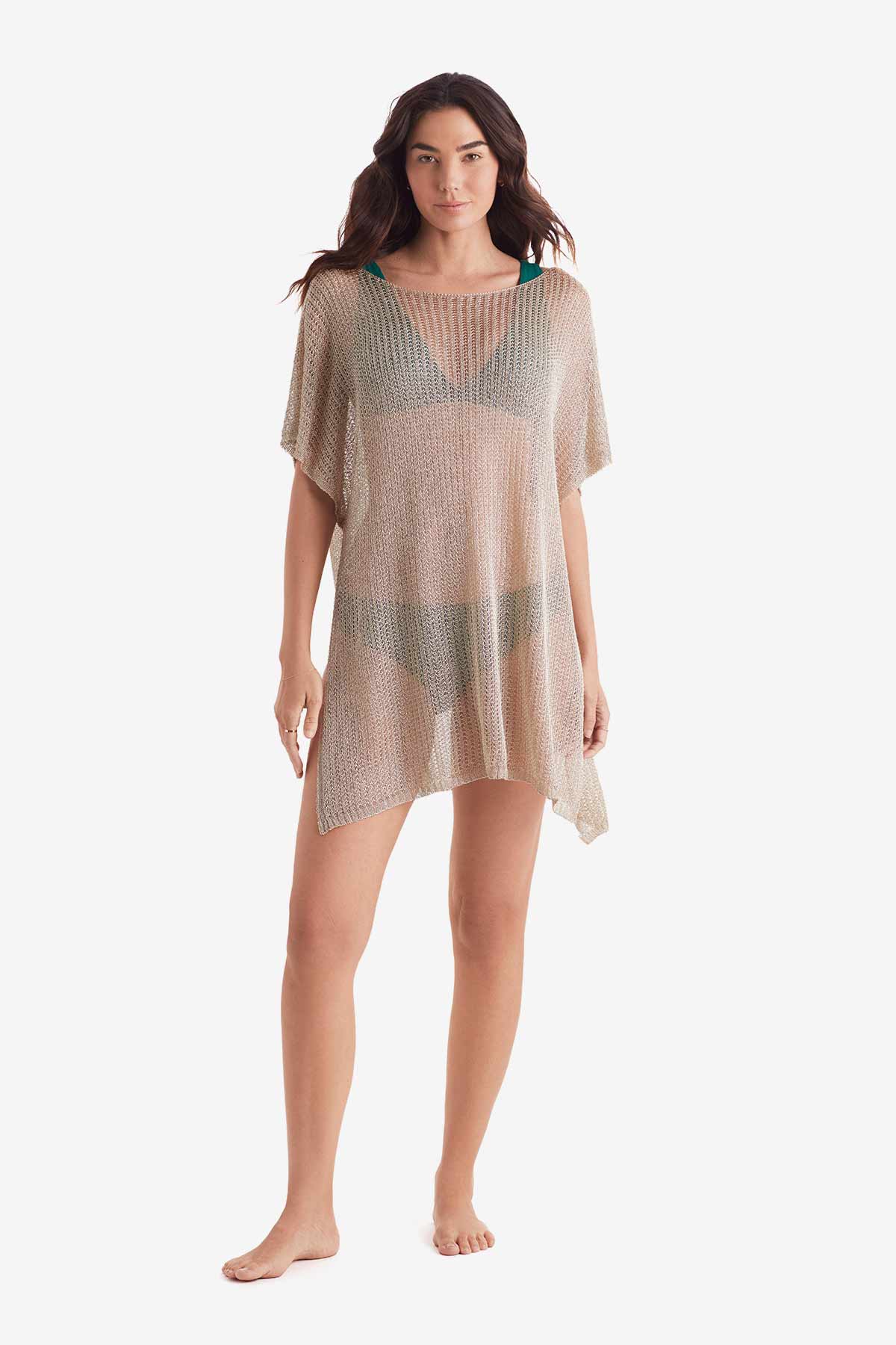 Woman wearing a tunic swim dress cover up in metallic gold