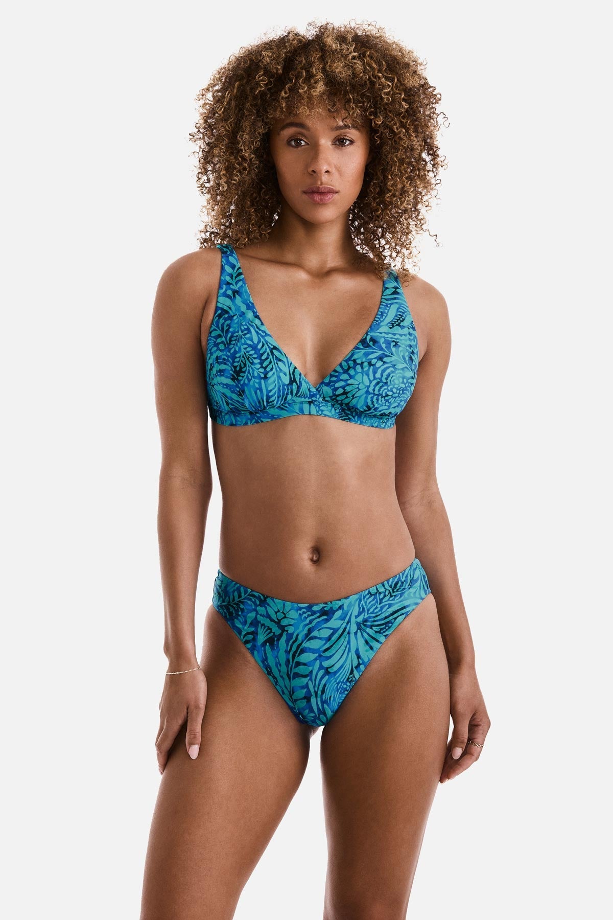 Woman wearing a blue abstract printed bikini top with matching swim bottoms